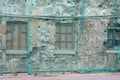 Brick wall covered green facade mesh