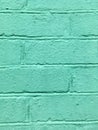 Brick wall covered with green paint. Abstract construction texture. Minimalism. Royalty Free Stock Photo
