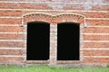 Brick wall with dark window holes Royalty Free Stock Photo