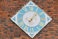 Brick wall with diamond shaped clock Royalty Free Stock Photo