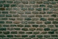 Brick wall with even rows of red and gray bricks. Brick pole texture background Royalty Free Stock Photo