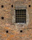 Brick wall exterior view with iron grid window