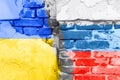 a brick wall with the flags of ukraine and russia as a symbol of the destruction of war. Diplomatic relations Royalty Free Stock Photo