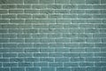 The brick wall is gray-green with white joining. Creative vintage background.