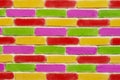 Brick wall, with green purple red and yellow painted bricks. Royalty Free Stock Photo