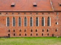 Brick wall with high gothic windows of castle chapel in Malbork, Poland
