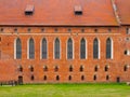 Brick wall with high gothic windows of castle chapel in Malbork, Poland