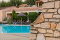 Brick wall with natural stones at the swimming pool of a touristic holiday resort in southern france. Royalty Free Stock Photo