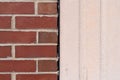 Brick wall next to a poured exterior concrete wall with expansion joint