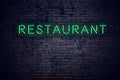 Brick wall at night with neon sign restaurant Royalty Free Stock Photo