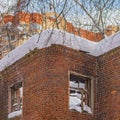 A brick wall of an old abandoned house with broken glasses in the windows Royalty Free Stock Photo