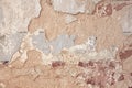 Old flaky white paint peeling off a grungy cracked wall. Cracks, scrapes, peeling old paint and plaster on background of old Royalty Free Stock Photo