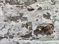 Brick wall with old white peeling plaster. Abstract Texture, background, pattern. Place for text and copy space. Vintage Royalty Free Stock Photo