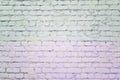 Brick wall painted with pale lilac and gray paint. Background with texture.