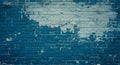 A brick wall with peeling paint revealing a mix of teal and light blue colors. The Royalty Free Stock Photo