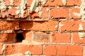 Brick wall red color with hole, construction background. Old cracked dirty brick with concrete, horizontal bright photo on a Royalty Free Stock Photo