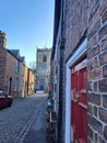 Brick wall with red door, church street in Croston, England Royalty Free Stock Photo