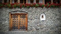 Brick wall, red flowers, windows, traditional Royalty Free Stock Photo