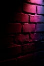 A brick wall with a red light shining through it Royalty Free Stock Photo