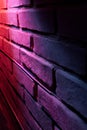 A brick wall with a red light shining through it Royalty Free Stock Photo