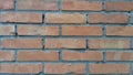 Brick wall of red-orange bricks and blocks. Lightly worn surface. Neat masonry, cement between the rows. Grunge background. Royalty Free Stock Photo