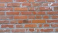 Brick wall of red-orange bricks and blocks. Lightly worn surface. Neat masonry, cement between the rows. Grunge background. Royalty Free Stock Photo