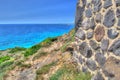 Brick wall by the shore in Sardinia Royalty Free Stock Photo