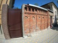 Brick wall with a solid iron door on a city street Royalty Free Stock Photo