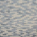 A brick wall with a staggered pattern composed of alternating gray and beige Royalty Free Stock Photo
