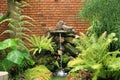Brick wall stones and little water fall in garden Royalty Free Stock Photo