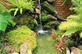 Brick wall stones and little water fall in garden Royalty Free Stock Photo