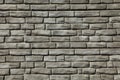 Brick wall texture, background in grey, faded color. Masonry-style concrete wall. Stylish fencing, made of decorative stone Royalty Free Stock Photo