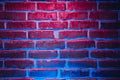 Brick wall texture background in red and blue neon lights Royalty Free Stock Photo