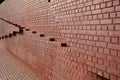 Brick wall from tiling without joints. very smooth stacked red wall. very nicely stacked with black pieces on the corners of a hou