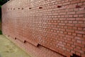 Brick wall from tiling without joints. very smooth stacked red wall. very nicely stacked with black pieces on the corners of a hou