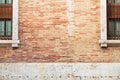 Brick wall between two old windows, background with copy space to place text Royalty Free Stock Photo