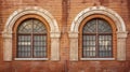 brick wall with two windows Royalty Free Stock Photo