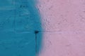 The brick wall was painted with blue and pink spray paint