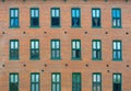Brick wall and windows facade of urban apartments Royalty Free Stock Photo