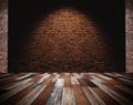 Brick wall and wood floor, light spot on center for background Royalty Free Stock Photo