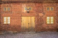 Brick Wall with Yellow Windows and Door