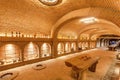 Brick walls of old wine cellar Khareba Winery with many bottles in underground cool room