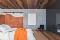 Brick and wooden loft master bedroom with poster Royalty Free Stock Photo