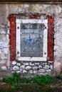 Bricked window in stone wall