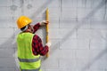 Bricklayer builder using the water level, check the inclination of autoclaved aerated concrete blocks. Walling, installing bricks