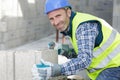 bricklayer builder working with autoclaved aerated concrete blocks