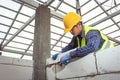Bricklayer builder working with autoclaved aerated concrete blocks. Walling, installing bricks in construction site Royalty Free Stock Photo