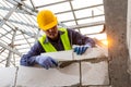 Bricklayer builder working with autoclaved aerated concrete blocks. Walling, installing bricks on construction site, Engineering Royalty Free Stock Photo