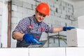 Bricklayer builder working with autoclaved aerated concrete blocks. Walling, installing bricks on construction site, Engineering Royalty Free Stock Photo