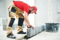 Bricklayer builder working with ceramsite concrete blocks. Walling Royalty Free Stock Photo